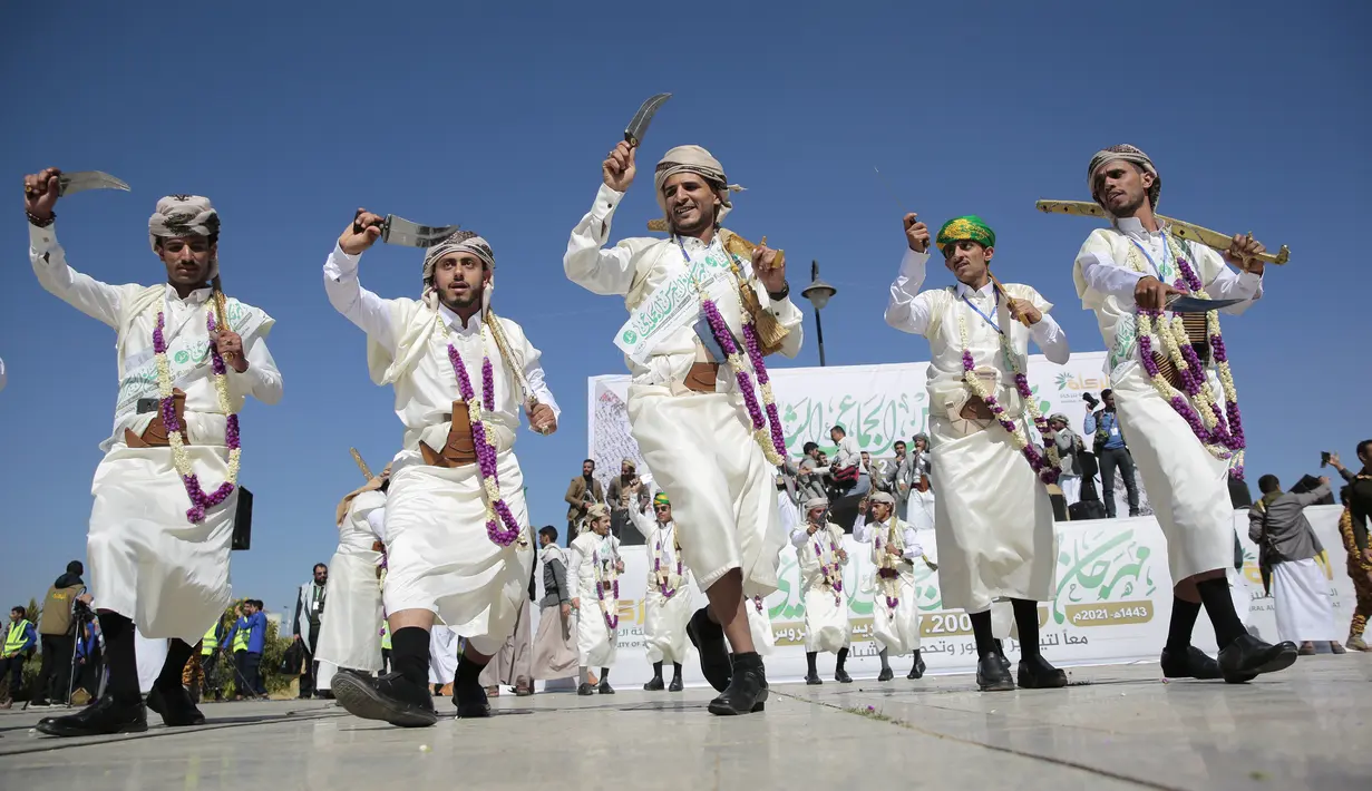 Sejumlah pengantin pria menari dengan mengenakan pakaian tradisional saat nikah massal di Sanaa, Yaman, 2 Desember 2021. Houthi mengadakan nikah massal untuk ribuan pasangan. (AP Photo/Hani Mohammed)