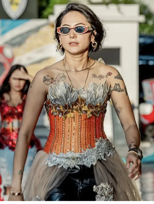 Poppy pun melengkapi penampilan mengenakan kalung yang menghiasi lehernya dan anting-anting hoopsnya. Ia pun nampak bergaya mengenakan kaca mata hitamnya.  Credit: Instagram  (@popsovia)