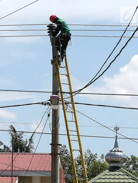 Petugas PLN memperbaiki jaringan listrik di Palu, Sulawesi Tengah, Sabtu (6/10). Sekitar 40 persen kondisi listrik di Kota Palu, Sulawesi Tengah (Sulteng), telah pulih. (Liputan6.com/Fery Pradolo)