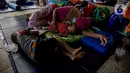 Warga korban banjir Cipinang Melayu beristirahat saat mengungsi di Masjid Universitas Borobudur, Jakarta, Minggu (21/2/2021). Sebanyak 60 orang warga dari RW 04 Kelurahan Cipinang Melayu mengungsi karena permukimannya terendam banjir akibat luapan air Kali Sunter. (Liputan6.com/Faizal Fanani)