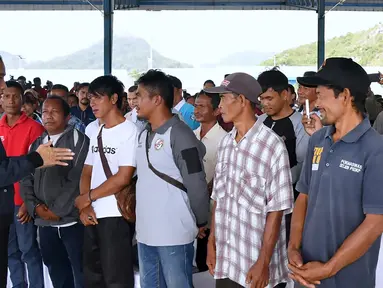 Presiden Joko Widodo (kiri) berbincang dengan nelayan Natuna saat melakukan kunjungan kerja di Sentra Kelautan Perikanan Terpadu (SKPT), Natuna, Kepulauan Riau, Rabu (8/1/2020). Kunjungan Jokowi tersebut pascakapal coast guard milik China berlayar di perainan laut Natuna (HO/PRESIDENTIAL PALACE/AFP)