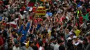 Penonton tetap antusias hadir di Sirkuit Interlagos, Brasil, Minggu (13/11/2016), walau hujan deras mengguyur sepanjang balapan F1 digelar. (AFP/Nelson Almeida)