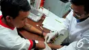 Dokter memberikan suntikan kepada seorang warga binaan Lapas Narkotika Kelas IIA Jakarta saat memperingati Hari AIDS/HIV sedunia, Jakarta, Senin (1/12/2014). (Liputan6.com/Johan Tallo)