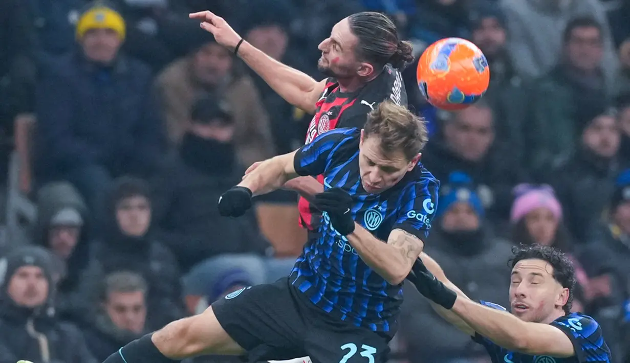 Pemain AC Milan, Adrien Rabiot, duel udara dengan pemain Inter Milan, Nicolo Barella, pada laga Italia di Stadion Giuseppe Meazza, Senin (2411/2025). (AP Photo/Antonio Calanni)
