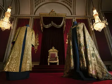 Jubah Penobatan, yang terdiri dari Supertunica (kiri) dan Imperial Mantle ditampilkan di Ruang Tahta di Istana Buckingham, London, pada 26 April 2023. Jubah ini akan dikenakan oleh Raja Charles III saat penobatannya di Westminster Abbey pada 6 Mei mendatang. (Victoria Jones/PA via AP)