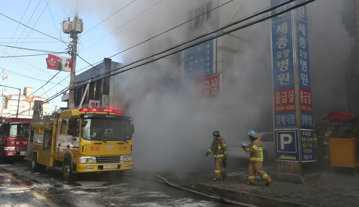 Petugas pemadam kebakaran berjibaku memadamkan kebakaran yang melanda rumah sakit Sejong, di Milyang, Korea Selatan,  Jumat (26/1). Setidaknya 31 orang tewas dan lebih dari 50 lainnya cedera dalam kebakaran maut tersebut. (Kim Dong-mi/Yonhap via AP)