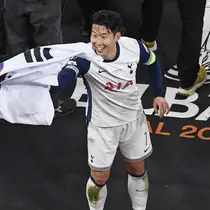 Pemain Tottenham Hotspur, Son Heung-min menangkap bendera Korea Selatan yang dilemparkan oleh penonton setelah laga final Liga Europa 2024/2025 melawan Manchester United di Stadion San Mames, Bilbao, Spanyol, Kamis (22/05/2025) WIB. (AFP/Ander Gillenea)