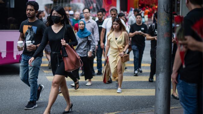 Seorang wanita mengenakan masker di tengah kekhawatiran akan penyebaran virus corona COVID-19, di Kuala Lumpur, Malaysia, Kamis, (13/2/2020). Total kematian akibat virus tersebut di Provinsi Hubei hingga Rabu (12/2) mencapai 1.310 orang. (AFP/Mohd Rasfan)