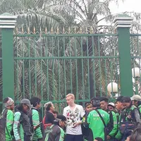 Mengenakan kaos berwarna putih si bule terlihat berada dikerumunan demo driver ojek online. (Foto: Facebook/Badar Adi)