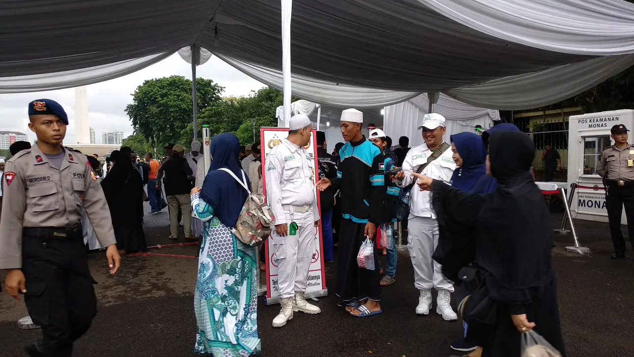 Peserta acara Munajat 212 diperiksa sebelum memasuki lokasi acara. (Liputan6.com/Nafiysul Qodar)