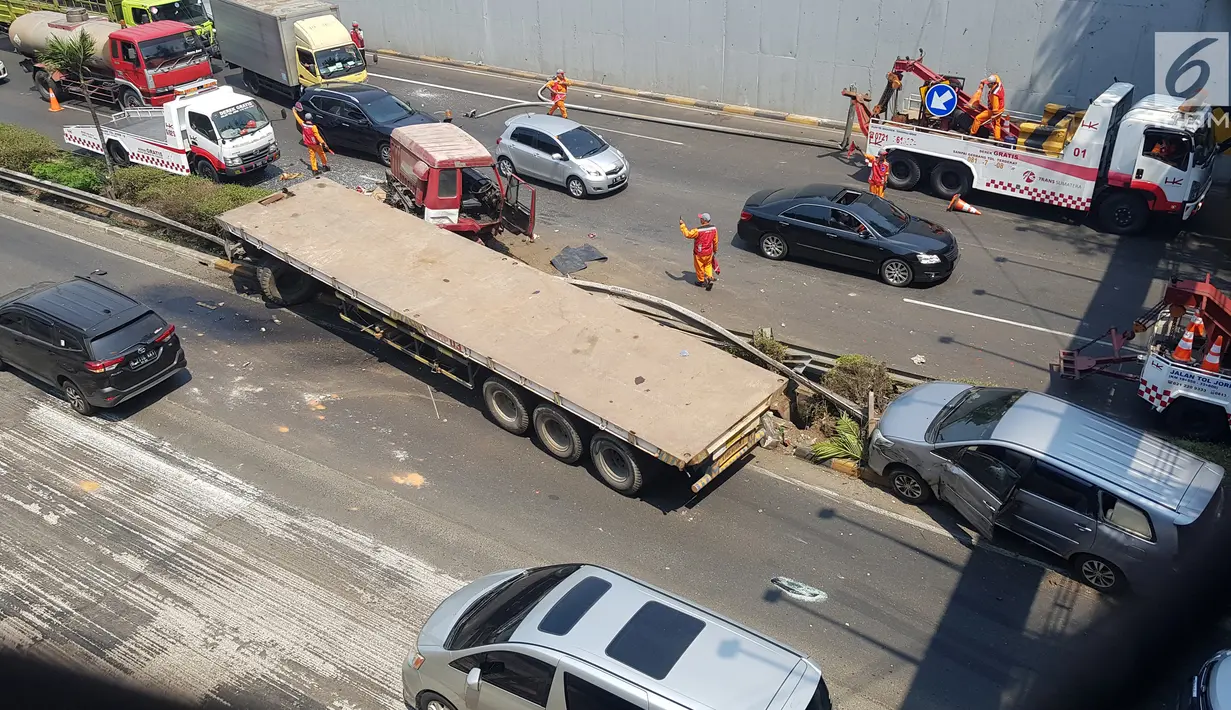 Petugas mengatur arus lalu lintas usai terjadi kecelakaan truk trailer dengan minibus di Tol JORR TB Simatupang Km 29, Jakarta, Jumat (30/8/2019). Kecelakan terjadi di Tol JORR TB Simatupang arah Kampung Rambutan. (Liputan6.com/Herman Zakharia)