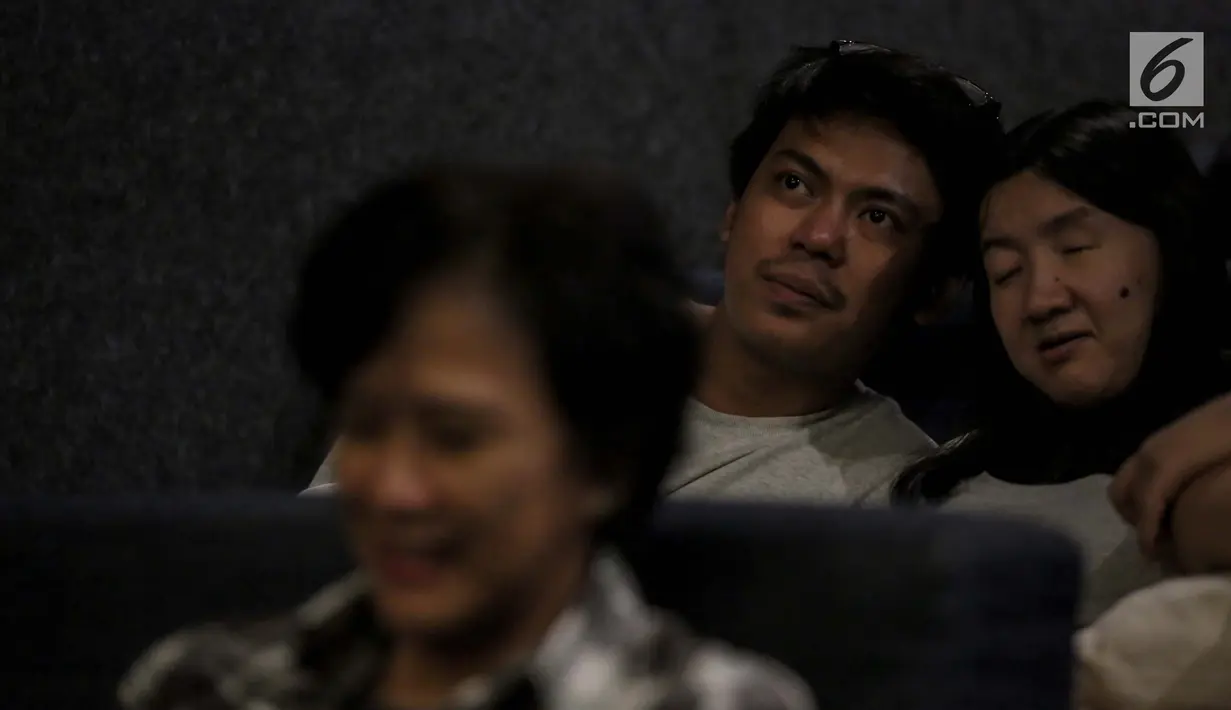 Relawan bisik menjelaskan alur film kepada penyandang tunanetra saat menyaksikan film di Bioskop Bisik di Pavilliun 28, Jakarta, Minggu (14/1). Kini, menonton bioskop bukan menjadi hal mustahil lagi bagi penyandang tunanetra. (Liputan6.com/Faizal Fanani)