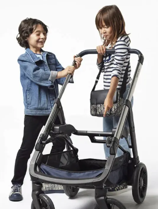 Stroller bayi Dior ini bisa dilipat dua arah, bisa direbahkan ke posisi tidur, dan kap integralnya anti UV, yang bisa dilepas dan dicuci. Aksesori tambahannya ada full rain cover, cup holder, dan keranjang khusus. Foto: Dior.
