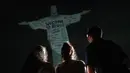 Patung Kristus Penebus setinggi 125 kaki ini diterangi dengan sebuah pesan yang menyambut kedatangan Taylor Swift ke negara ini untuk rangkaian terakhir dari Eras Tour-nya. (AP Photo/Bruna Prado)