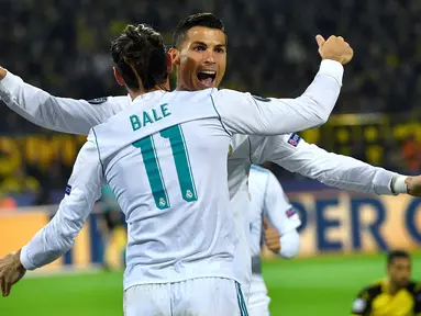 Pemain Real Madrid, Cristiano Ronaldo dan Gareth Bale berselebrasi setelah mencetak gol ke gawang Borussia Dortmund dalam lanjutan Liga Champions di Signal Iduna Park, Rabu (27/9). Duet Ronaldo dan Bale mengantarkan Madrid menang 3-1. (AP/Martin Meissner)