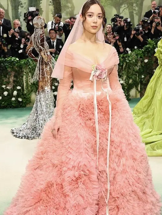 Penyanyi-penulis lagu Islandia Laufey mengenakan gaun pink dari Prabal Gurung. Gaun tersebut memiliki detail pinggang korset dengan leher dan lengan terbungkus tulle. Dihiasi roset surra handmade dengan rok  ruffle organza. [@prabalgurung]
