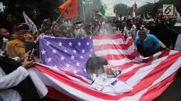 Massa aksi melakukan unjuk rasa dengan membakar bendera Amerika Serikat (AS) di depan Kedubes AS, Jakarta, Senin (11/12). Massa dari berbagai organisasi masyarakat itu juga menuntut agar Duta Besar AS hengkang dari Indonesia. (Liputan6.com/Faizal Fanani)