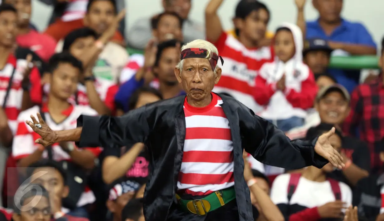 Suporter Madura United menari jelang menyaksikan timnya berlaga melawan Persija pada lanjutan Liga 1 di Stadion Patriot Candrabhaga, Bekasi, Kamis (4/5). Madura United FC unggul 1-0. (Liputan6.com/Helmi Fithriansyah)