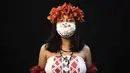 Yusuro Dupohtiro (15) dari kelompok etnis pribumi Dessana dan Sateré Mawé mengenakan pakaian tradisional sukunya dan masker saat pandemi virus corona COVID-19 di Manaus, Brasil, Rabu (27/5/2020). (AP Photo/Felipe Dana)