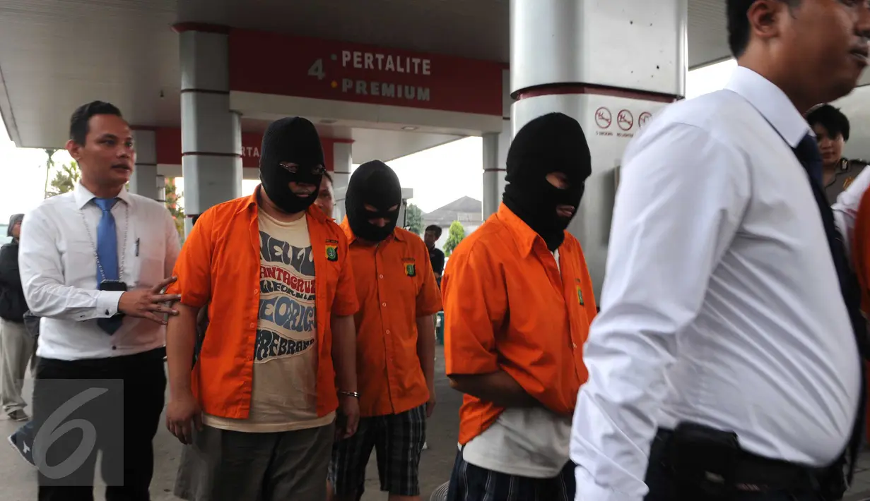 Petugas membawa sejumlah tersangka dalam gelar perkara di SPBU kawasan Rempoa, Ciputat, Tangsel, Senin (6/6). Praktek pengurangan takaran pengisian bahan bakar di SPBU bernomor 34 12305 tersebut akhirnya dibongkar petugas. (Liputan6.com/Helmi Afandi)