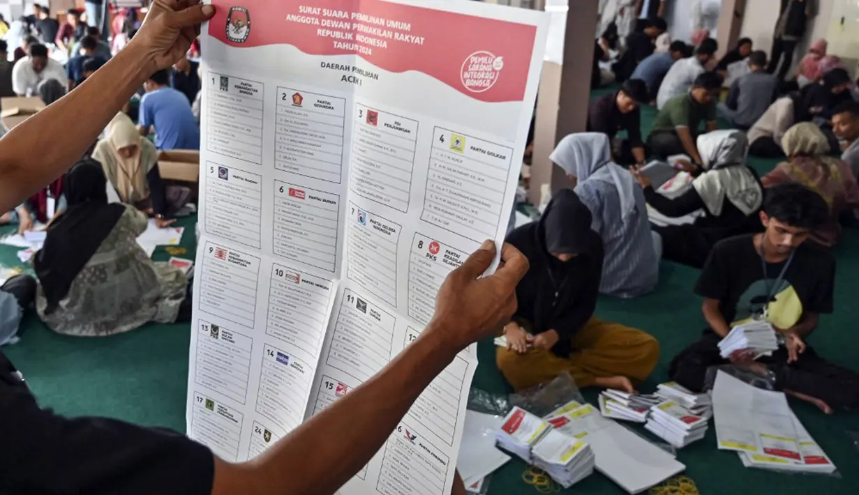 Yusri Razali mengingatkan petugas penyortiran dan pelipatan agar teliti memeriksa dan melipat surat suara tersebut. Ada beberapa kategori surat suara yang dinyatakan rusak seperti pencetakannya tidak jelas, ada lubang di kolom pemilihan, dan lainnya. (CHAIDEER MAHYUDDIN/AFP)