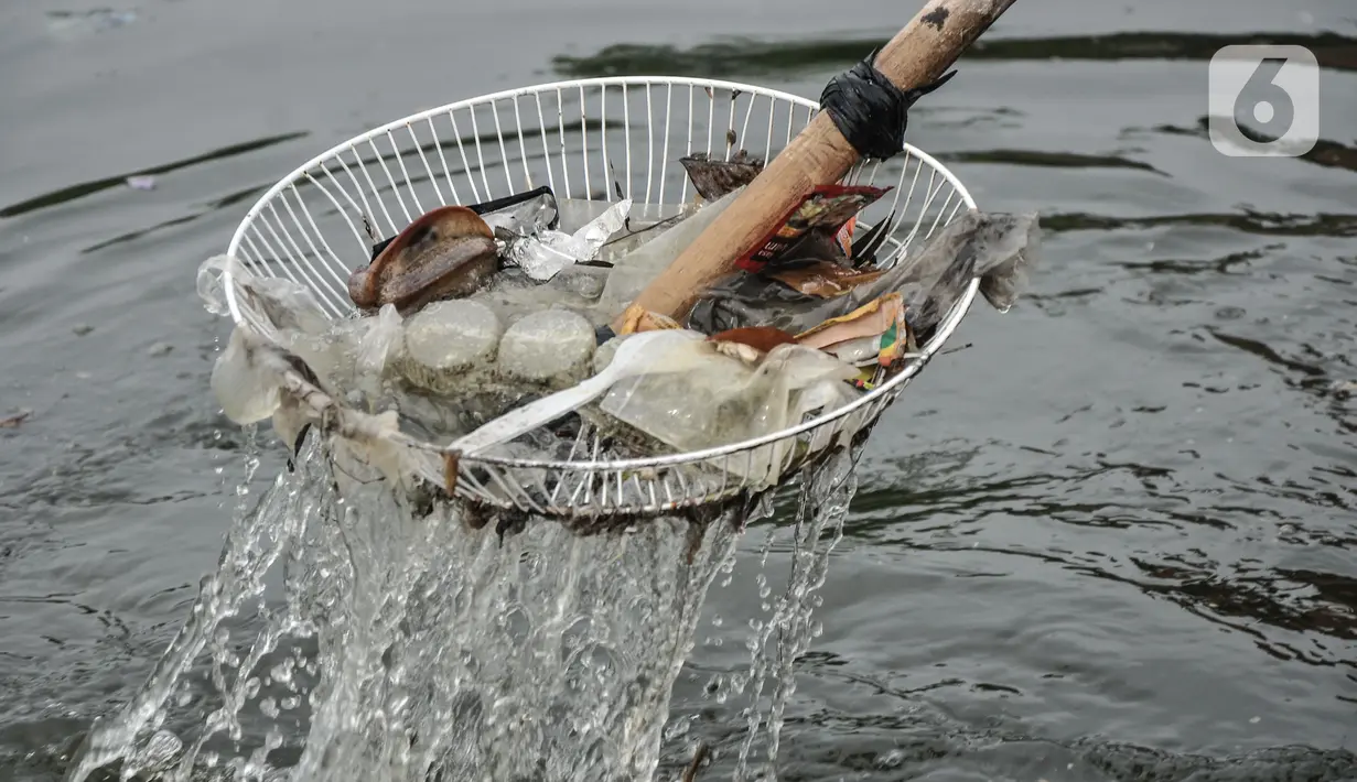 Petugas UPK Badan Air Dinas Lingkungan Hidup saat membersihkan sampah yang mencemari Waduk Cincin, Jakarta Utara, Rabu (23/6/2021). Pengerukan sampah dilakukan secara rutin guna menjaga kebersihan dan keindahan waduk, terutama saat memasuki musim penghujan. (merdeka.com/Iqbal S Nugroho)