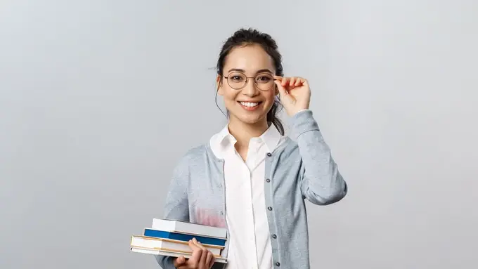 Seorang perempuan memegang kacamata (Foto Dok: Freepik/EyeEm)