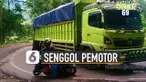 Sebuah truk besar senggolan dengan sepeda motor di jalan tikungan.