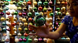 Seorang pengunjung menunjukan Bola Pengharapan (Wishing Ball) di Mall Central Park, Jakarta, Senin (19/12). Bola Pengharapan (Wishing Ball) ini merupakan rangkaian acara "Now Jakarta The Christmas City". (Liputan6.com/Johan Tallo)