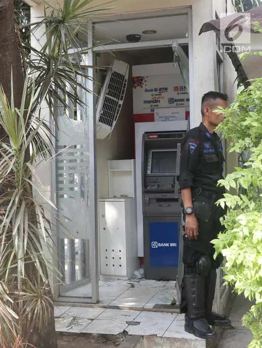 Petugas menjaga Anjungan Tunai Mandiri (ATM) yang porak poranda akibat kericuhan massa aksi di sekitar Gedung Bawaslu, Jalan MH Thamrin, Jakarta, Kamis (23/5/2019). Sebelumnya, aksi unjuk rasa yang dilakukan massa pada Rabu (23/5) berakhir ricuh. (Liputan6.com/Helmi Fithriansyah)