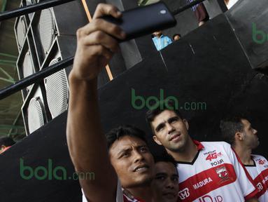 Suporter Madura United FC mengajak berselfie-ria pemain asing Fabiano Beltrame, Toni Espinosa Mossi, dan Pablo Rodriguez Aracil di Stadion Ahmad Yani, Sumenep, Sabtu (20/2/2016). (Bola.com/Vitalis Yogi Trisna)