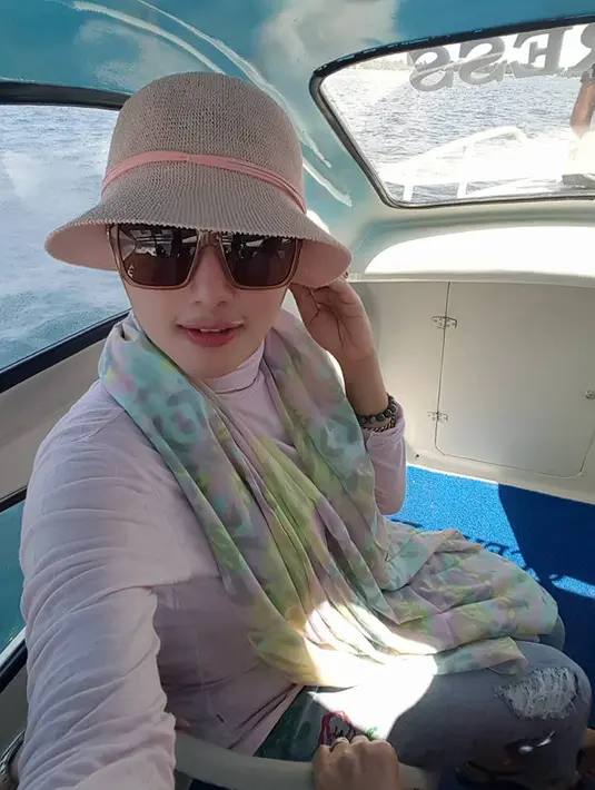 Bukan Yulia sepertinya kalau tak bergaya mewah dan glamor. Kali ini masih dalam nuansa liburan, dan pastinya Yulia tetap tampil cantik. Ia mengenakan busana bernuansa pastel dan tak lupa dengan topi dan kacamata hitamnya. (Doc.Facebook)