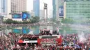 <p>Sejumlah suporter melakukan perayaan bersama pemain Timnas Indonesia U-22 saat mengikuti parade perayaan kesuksesan Timnas Indonesia U-22 di SEA Games 2023 Kamboja di Bundaran Hotel Indonesia, Jakarta, Jumat (19/05/2023). (Bola.com/M Iqbal Ichsan)</p>