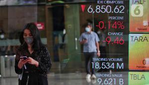 Karyawan melintasi layar yang menampilkan Indeks Harga Saham Gabungan (IHSG) saat acara Penutupan Perdagangan Bursa Efek Indonesia Tahun 2022 di Jakarta, Jumat (30/12/2022). PT Bursa Efek Indonesia (BEI) mencatat ada 59 perusahaan yang melakukan Initial Public Offering (IPO) atau pencatatan saham sepanjang 2022. Pada penutupan perdagangan akhir tahun, Indeks Harga Saham Gabungan (IHSG) ditutup lesu 0,14% atau 9,46 poin menjadi 6.850,62. (Liputan6.com/Angga Yuniar)