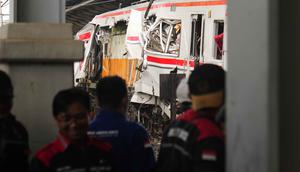 Para pekerja memeriksa kondisi lokomotif Kereta Api Jarak Jauh (KAJJ) Argo Bromo Anggrek dan salah satu gerbong Kereta Rel Listrik (KRL) Commuter Line yang mengalami kecelakaan di Stasiun Bekasi Timur, Bekasi, Jawa Barat, Selasa 28 April 2026. (AP Photo/Tatan Syuflana)