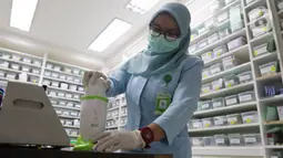 Tenaga farmasi meracik obat di RSIA Tambak, Jakarta, Jumat (21/10/2022). Kemenkes sudah meminta tenaga kesehatan pada fasilitas pelayanan kesehatan untuk sementara tidak meresepkan obat-obatan dalam bentuk sediaan cair/sirup, sampai hasil penelusuran dan penelitian mengenai gangguan ginjal akut pada anak tuntas. (Liputan6.com/Herman Zakharia)