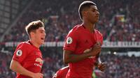 Striker Manchester United, Marcus Rashford, merayakan gol yang dicetaknya ke gawang Leicester pada laga Premier League 2019/2020 di Stadion Old Trafford, Manchester, Sabtu (14/9). MU menang 1-0 atas Leicester. (AFP/Oli Scarff)
