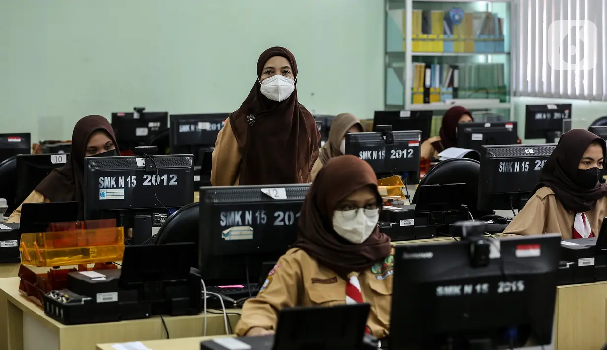 Pengawas mengecek selama pelaksanaan Asesmen Nasional  Berbasis Komputer (ANBK) 2021 di SMK 15, Jakarta, Rabu (22/9/2021). ANBK  SMK  digelar 20-23 September 2021 dengan mematuhi protokol kesehatan dan ANBK merupakan pengganti Ujian Nasional (UN). (Liputan6.com/Johan Tallo)