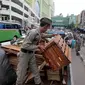 Barang-barang dari PKL diangkut Satpol PP di Pasar Tanah Abang, Jakarta, Kamis (4/5). Penertiban dilakukan agar tidak menggangu fungsi pedestrian untuk pejalan kaki. (Liputan6.com/Johan Tallo)