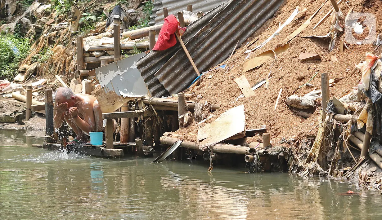 Warga cuci muka di bantaran Sungai Ciliwung, Kampung Tanah Rendah, Jakarta, Jumat (15/11/2019). Pemprov DKI Jakarta membatalkan pembebasan 118 bidang tanah di bantaran Sungai Ciliwung yang disebabkan karena defisit anggaran. (Liputan6.com/Herman Zakharia)