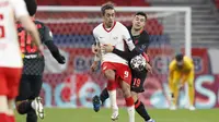 Bek Liverpool, Ozan Kabak, berebut bola dengan pemain RB Leipzig, Yussuf Poulsen, pada laga Liga Champions di Stadion Puskas, Rabu (17/2/2021). Liverpool menang dengan skor 2-0. (AP/Laszlo Balogh)