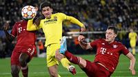 Penyereang Villarreal, Gerard Moreno (tengah) berebut bola dengan bek Bayern Munchen Dayot Upamecano dan Benjamin Pavard pada pertandingan leg pertama perempat final Liga Champions di stadion La Ceramica di Vila-real, Kamis (7/4/2022). Villarreal menang tipis atas Bayern Munchen 1-0. (AFP/Pierre-Phi