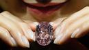 Berlian 59,6 karat yang dijuluki sebagai Pink Star dilelang Sotheby’s di Hong Kong, Selasa (4/4). Berlian ini terjual $ 71,2 juta (Rp.949 M) jauh melampaui perkiraan yang hanya $ 60 juta. (AFP Photo/ ANTHONY WALLACE)