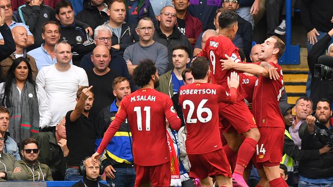 Para pemain Liverpool merayakan gol yang dicetak Trent Alexander Arnold ke gawang Chelsea pada laga Premier League di Stadion Stamford Bridge, London, Minggu (22/9). Chelsea kalah 1-2 dari Liverpool. (AFP/Olly Greenwood)