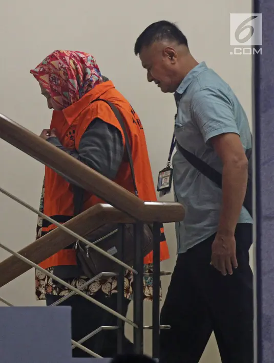 Panitera Pengganti PN Tangerang, Tuti Atika kenakan rompi oranye usai diperiksa di gedung KPK, Jakarta, Selasa (13/3). Tuti Atika terjaring operasi tangkap tangan terkait penerima suap dugaan perdata perkara wanprestasi. (Liputan6.com/Herman Zakharia)