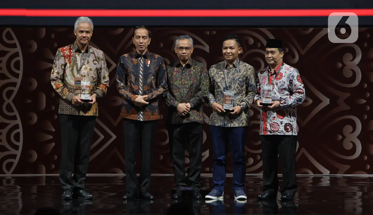 Presiden Joko Widodo (kedua kiri) didampingi Ketua Dewan Komisioner Otoritas Jasa Keuangan (OJK) Wimboh Santoso (tengah) berfoto bersama tiga penerima penghargaan dalam Pertemuan Tahunan Industri Jasa Keuangan Tahun 2020 di Jakarta, Kamis (16/1/2020). (Liputan6.com/Angga Yuniar)