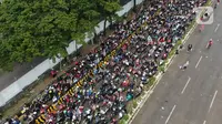 Pantauan udara ribuan pemudik sepeda motor memadati pelabuhan Merak Banten, Sabtu (30/4/2022). H-2 Lebaran atau Puncak Arus Mudik, pelabuhan Merak diserbu ribuan pemudik motor. (Liputan6.com/Angga Yuniar)