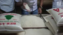 Tim Satgas Pangan Polda Metro Jaya dan Perum Bulog mengecek kualitas beras saat melakukan peninjauan di Pasar Tomang Barat, Jakarta, Rabu (21/11). Kegiatan tersebut untuk memantau stabilitas harga beras medium di pasaran. (Liputan6.com/Faizal Fanani)