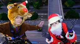 Dua petugas berkostum Santa Claus dan rusa bersiap turun untuk membersihkan kaca-kaca gedung bertingkat di pusat perbelanjaan di Tokyo, Kamis (21/12). Wajah sang Santa hampir tak terlihat karena tertutupi jenggot putih dan topinya. (AP/Shizuo Kambayashi)