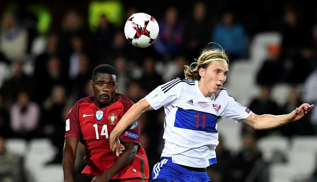 Pemain Portugal, William Carvalho (kiri), berebut bola dengan pemain Kepulauan Faroe, Joan Edmundsson, pada laga Grup B Kualifikasi Piala Dunia 2018 zona Eropa di Torsvollur Stadium, Selasa (11/10/2016) dini hari WIB. (AFP/Francisco Leong)